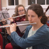 Two people playing flutes
